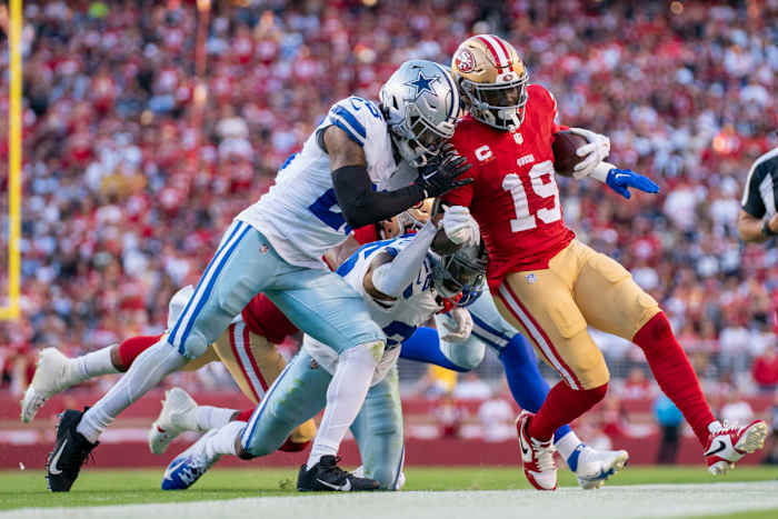 San Francisco 49ers wide receiver Deebo Samuel (19) is pushed out of bounds by Dallas Cowboys safety Malik Hooker (28) and cornerback DaRon Bland (26) during the first quarter at Levi's Stadium.